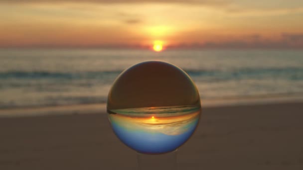 砂の山のクリスタルボールの中の日没の島の景色 ビーチビデオのクリスタルボールの場所で海の上の夕日 自然ビデオ 自然と旅行のコンセプトで高品質の映像 — ストック動画