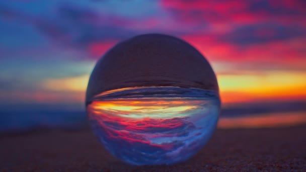 在沙滩上的水晶球里 夕阳西下 天空五彩斑斓 — 图库视频影像