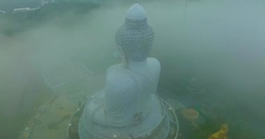 aerial view The Big Buddha of Phuket can only be seen as the head peeking out from the sea of mist..Phuket Big Buddha in the thick white mist. .A fluffy mist covers the Big Buddha in Phuket.