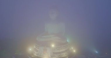 aerial view The Big Buddha of Phuket can only be seen as the head peeking out from the sea of mist..Phuket Big Buddha in the thick white mist. .A fluffy mist covers the Big Buddha in Phuket.