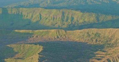 Penanjakan Dağı 'nın tepesinden Bromo Dağı' nın kraterinden sürekli beyaz duman püskürttüğünü görmek hayret verici bir manzara. Bromo volkanları tatlı gündoğumunda güzel bir şekilde hizalanmışlardı..