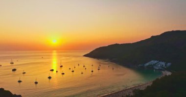 Nai Harn plajı Phuket 'te gün batımında hava manzarası güzel bulutlu. Renkli romantik gökyüzü günbatımı sahnesi. Tatlı gökyüzü deniz arkasını kaplıyor. Nai Harn sahilindeki marinada bir sürü yat var.
