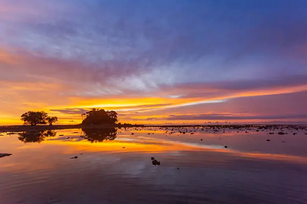 stock image amazing colorful cloud in sunset above Pling island at Naiyang beach Phuket. A peaceful twilight scene featuring a stunning gradient sky transitioning from deep purple to warm orange as night falls.