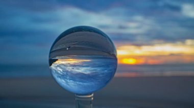 Camdan bir küre içindeki renkli akşam bulutlarının zaman aşımı