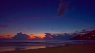 Bulutların ardında, denizin üzerinde güneşin batışı.