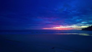 Karon sahili Phuket ufkunun üzerinde doğanın inanılmaz ışığıyla bir sahil günbatımı manzarasının sükuneti..