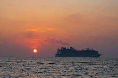 Lüks bir yolcu gemisinde güneş batarken gökyüzünü turuncu ve pembeye boyuyor ve nefes kesici bir manzara yaratıyor. Patong Sahili 'ndeki Phuket' te güne zarif geçiş sahneleri..