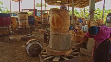 Tad davulunu yapan erkek ve kadın, ortasında delik olan büyük bir ahşap parçasından yapılmış çift taraflı bir davuldur..