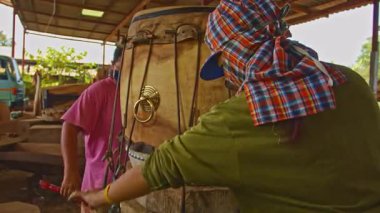 Davul her iki tarafında sığır derisi ya da bufalo derisi olan kütüklerden yapılmıştır. İğnelerle sabitlenir ve sıkılaştırılır. Sonra sığır derisi sıkılaşana kadar bekletilir. Davul, derin ve gürültülü bir ses çıkarır..