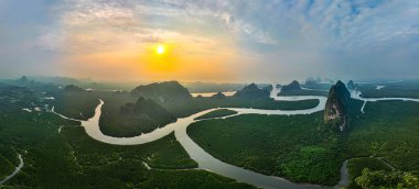 Bereketli yeşil bir mangrov ormanının muhteşem hava manzarası dolambaçlı kanalla kesişiyor, eşsiz ve karmaşık bir doğal manzara yaratıyor. Sahne, kıyı ekosisteminin zengin biyolojik çeşitliliğini gösteriyor