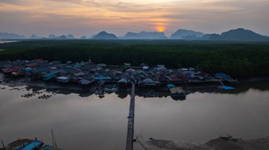 Küçük bir köprünün havadan görünüşü, mangrov ormanlarıyla çevrili küçük bir adada yaşayan bir balıkçı köyüne bağlanır. Önünde denize açılan bir kanal var, çeşitli deniz yaşamı açısından zengin..