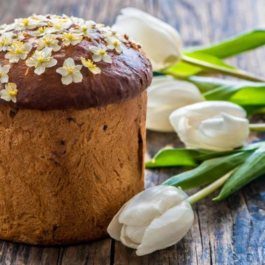 Paskalya yumurtası ve pasta gri masa arkasında. Bahar tatili için mutlu paskalya arkaplanı