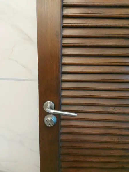 modern wooden door handle in the bathroom