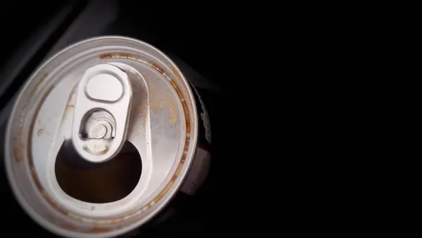 aluminum can full of soda can with a black background