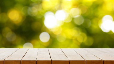 Bulanık yeşil arkaplandaki ahşap masa üstü ürünlerinizi görüntülemek veya montajlamak için kullanılabilir. Picknick in the sunshine