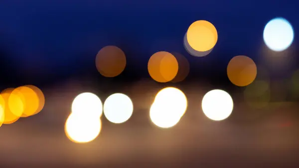 Abstract bokeh of car light on road at night streetlights background.