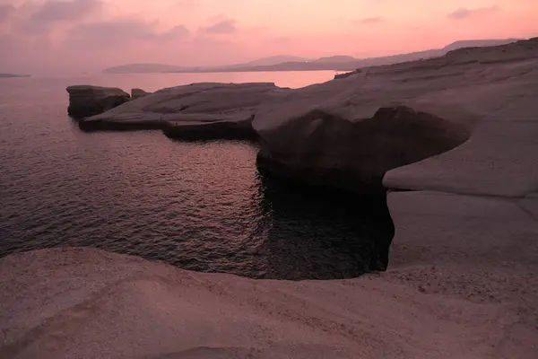 stock image Sunset Over White Stone Formations at Sarakiniko Beach, Milos Island, Greece