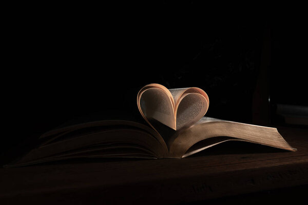 Book pages forming a romantic heart