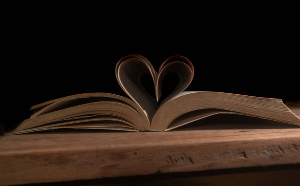 Book pages forming a romantic heart