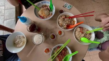Aile Çin sokak yemeği yiyor, düz yatak manzarası var. Laksa, kolo mee, wonton çorbası, tofu buzu, çay