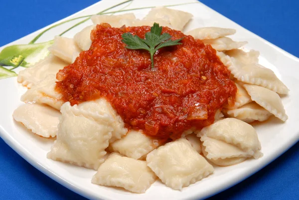 plate of fresh pasta cooked with pink cream tomato sauces and pesto over gnocchi ravioli noodles and homemade sorrentinos