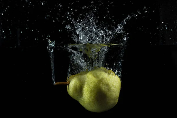fruits falling into the water forming a splash strawberries lemon oranges apples pears with a black background and water in the air