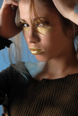 Sonbaharda yetişen genç bir kadın, yılın mevsimini kahverengi renklerle temsil eden bir ağacın kuru yapraklarıyla üretilmektedir. 