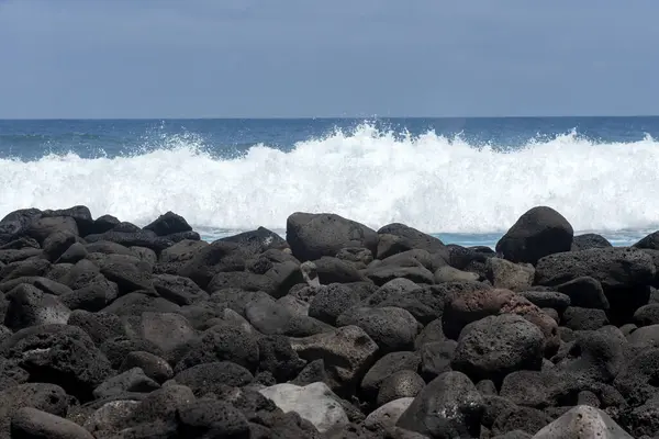 stock image beach landscape with the sea and waves and cliffs of the coasts of the Galapagos Islands in the Pacific Ocean with blue and green water and volcanic rocks 