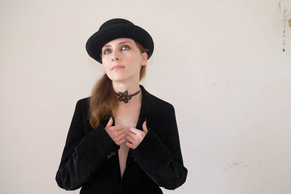 young beautiful woman in black leather jacket and black hat