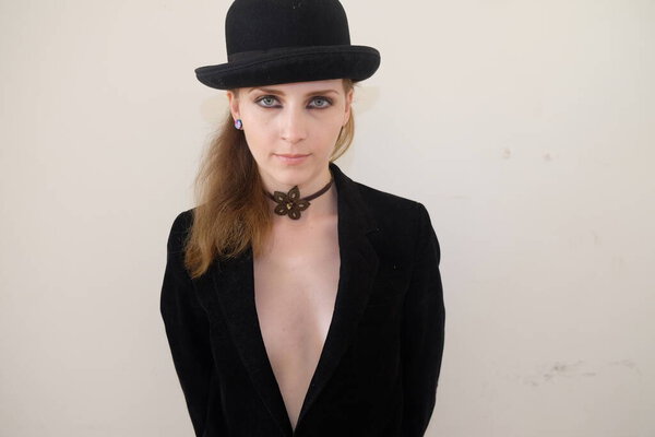 young woman in black hat