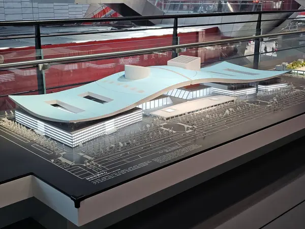 Shenzhen, Çin - 17 Ocak 2025: MOCAPE 'in ikonik' Bulut 'heykeli modern müze alanını keşfeden ziyaretçilerle birlikte geniş geometrik tavan penceresini yansıtıyor.