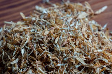 Calendula or pot marigold medicinal on wood background clipart