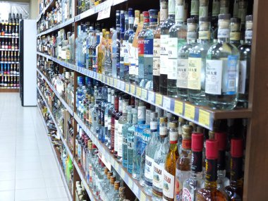 A storefront with liquor. Wine bottles in a row clipart