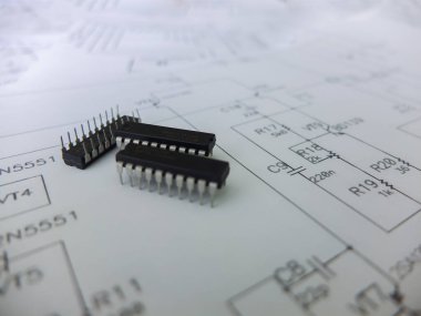 Various integrated circuits, microcontrollers in DIP SOIC TQFP packages. On the back there is a schematic diagram clipart