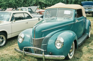 Auburn WA USA, 4 Temmuz 2025 - Klasik bir 4 Temmuz geleneği için klasik ulaşım meraklıları Les Gove Park 'ın antika arabalarına, kamyonlarına ve motosikletlerine hayran kalabilirler