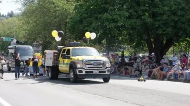 Woodinville, August 9, 2025 - City Day, parade on Main Street, balloon-decorated car driving down the road blowing soap bubbles