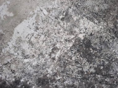 Karanlık ve aydınlık alanları olan kirli beton bir doku.