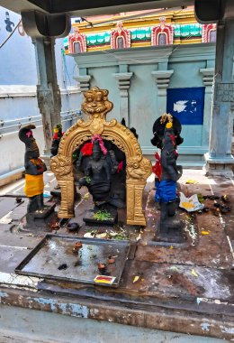 Statue of deity Shani, lord of the planet Saturn, with a raised hand giving blessing and with one foot resting on the crow, his servant. The symbols one of nine planets in the jyotish astrology. clipart