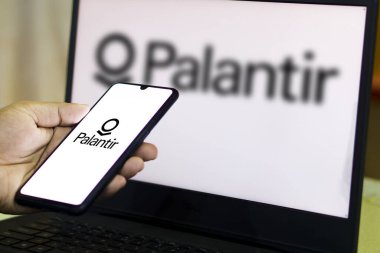 Palantir logosunda ABD 'li yazılım şirketi Palantir Technologies Inc.' nin logosunu taşıyan kişi ekranda. Telefon görüntülerine odaklan. Dhaka, Bangladeş - 07 Şubat 2024.