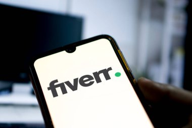Fiverr logosu bir akıllı telefonda sergileniyor. Şirketin adı Bangladeş, Dhaka, Bangladeş, 14 Mart 2024 'ten itibaren 5 dolardan başlayan hizmet sunma platformu.