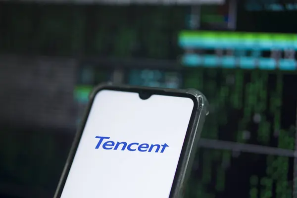 stock image Dhaka,Bangladesh 30 April 2024:Tencent Holdings Ltd. is a Chinese multinational technology conglomerate holding company. A smartphone with the Tencent logo in a clenched hand.