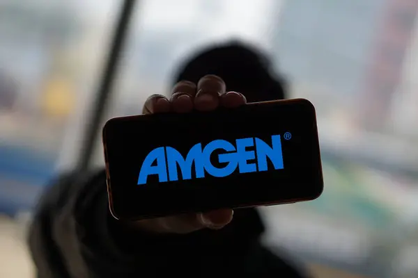 stock image Dhaka,Bangladesh 21 May 2024:Cellphone with logo of American biopharmaceutical company Amgen Inc.