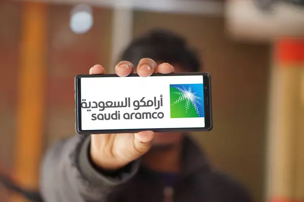 stock image  Dhaka,Bangladesh 28 July 2024:Person holding phone with logo of oil and gas company Saudi Aramco on smartphone.