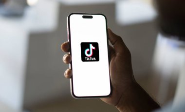 TikTok App is displayed on smartphone screen, TikTok logo is blurred in the background. A popular short videos social network on the internet,Dhaka,Bangladesh 05 September 2024. clipart