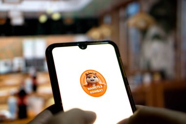 Hamster Kombat telegram bot on smartphone screen. Hamster Kombat is a viral Telegram-based crypto game for earn HMSTR tokens by managing a virtual crypto exchange-Dhaka,Bangladesh 16 September 2024. clipart