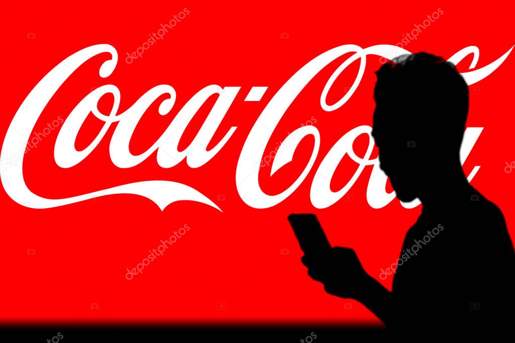 Coca-Cola logo is seen on a mobile phone and a computer screen-Dhaka,Bangladesh 11 Oct 2024.