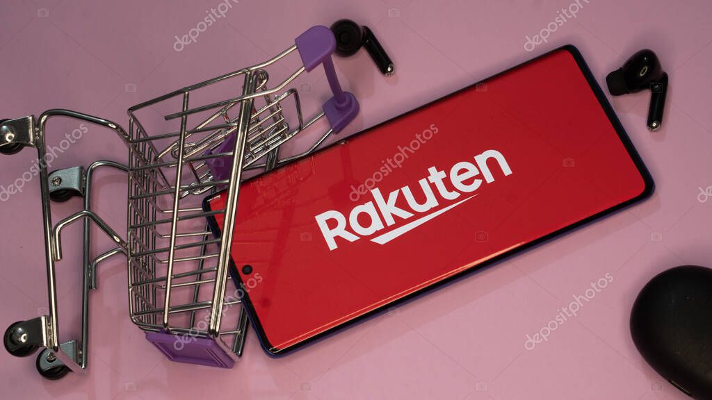 Dhaka, Bangladesh 19 April 2025: Rakuten Group is Japanese electronic commerce and online retailing company. Shopping cart with parcels on the background of the Rakuten logo.