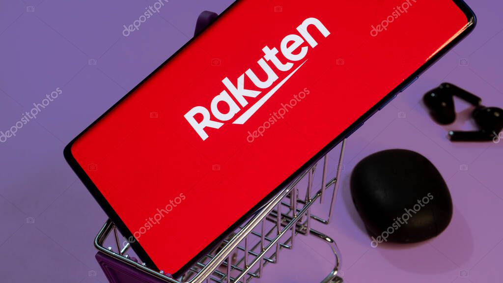 Dhaka, Bangladesh 19 April 2025: Rakuten Group is Japanese electronic commerce and online retailing company. Shopping cart with parcels on the background of the Rakuten logo.