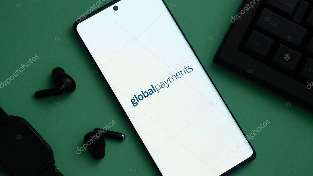 Dhaka, Bangladesh 04 May 2025: Global Payments Inc. on screen in front of webpage. Focus on phone display.