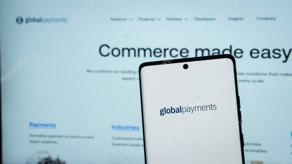 Dhaka, Bangladesh 04 May 2025: Global Payments Inc. on screen in front of webpage. Focus on phone display.